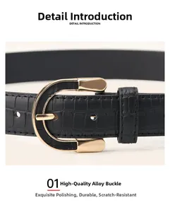 Detail of black faux crocodile leather belt featuring a premium gold alloy D-buckle