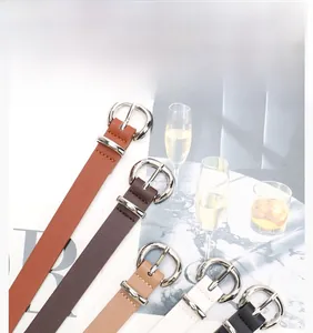 Detail showing five assorted leather belts with silver D-buckles and litchi texture