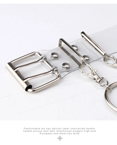 Detail of transparent PVC punk belt with silver double prong buckle and eyelets
