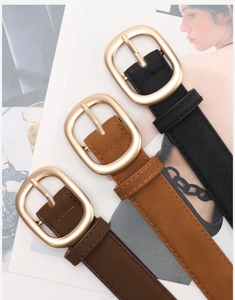 Detailed view of matte nubuck leather belts in black and brown with gold oval buckles