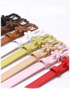 Detail of floral alloy buckles and colorful faux leather belts for women's dresses