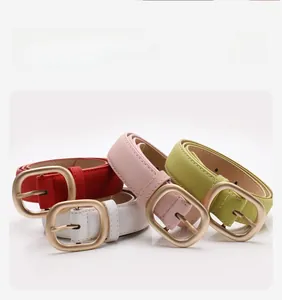 Detail of matte leather belts in multiple colors with golden oval metal buckles