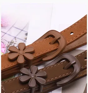 Detailed macro view of the 3D flower buckle on minimalist matte faux leather thin belts