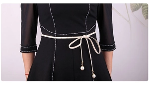 Detail of Korean style velvet waist rope with white pearls on a black dress