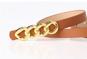 Close-up of brown leather belt with gold chain buckle showing fine texture and metallic shine