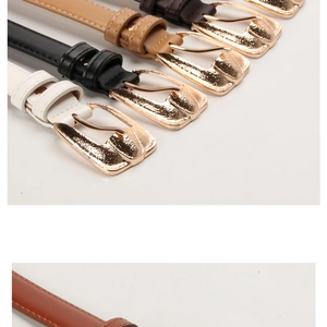 Macro detail of PU leather belts with textured gold horseshoe buckles in multiple colors