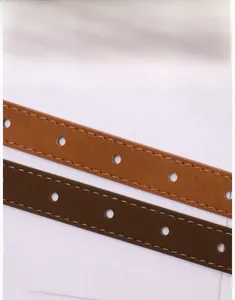 Detailed view of brown leather belt stitching and clean round hole punch craftmanship