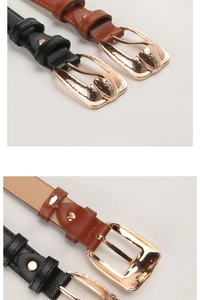 Detail of slim black and brown PU leather belts with gold geometric buckles on white background