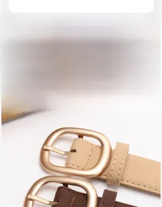 Close-up of matte gold rectangular buckle and fine stitching on nubuck leather belts