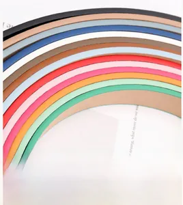 Collection of colorful minimalist leather belts for women showing a variety of vibrant hues