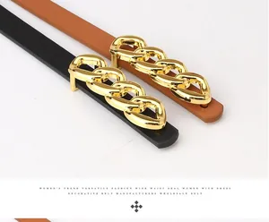Detailed close-up of fashion waist belts with large gold chain buckles in black and brown