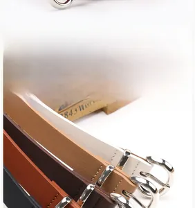 Detail of multi-color women's leather belts featuring silver alloy circular buckles