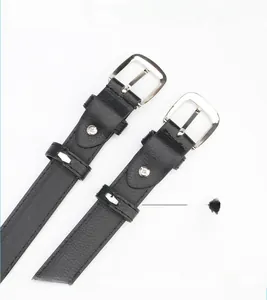 Detail of lychee pattern black leather belt showing stitching and silver metal buckle