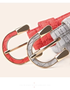 Detail view of crocodile pattern embossed leather belt with gold alloy buckle