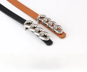 Detail shot of black and brown slim belts with metallic silver chain buckles for coats
