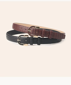 Close-up of stone pattern leather belts in black and brown with golden buckles