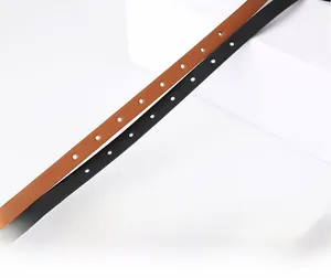 Detailed macro view of minimalist leather waist belts in black and brown with fine texture