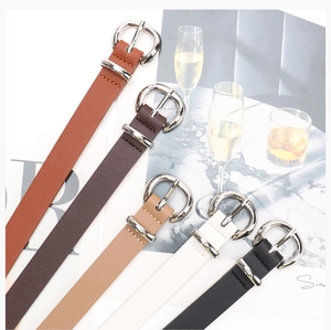 Close-up of minimalist leather belts for women with silver D-ring buckles in five colors
