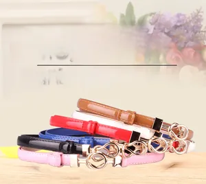 Macro detail of assorted thin leather belts with elegant golden double ring buckles