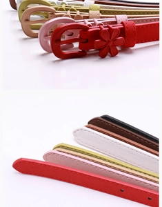 Close-up of stylish thin women's belt featuring a delicate floral accent and metal D-ring buckle