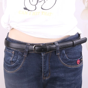 Women's black faux leather skinny belt with classic silver buckle on denim jeans