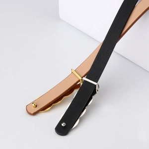 Minimalist women's leather belts with wave-shaped metal buckles in black and camel