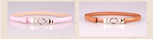 Close-up of pink and brown patent leather skinny belts with gold interlocking double rings