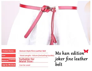 Détail d'une ceinture en cuir rouge nouée sur robe en dentelle blanche avec boucle