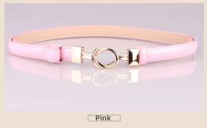 Detail of pink patent leather skinny belt with elegant gold double ring metal buckle