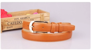 Close-up of women's brown PU leather belt with silver pin buckle and stitching details