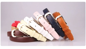 Detail view of colorful PU leather belts with classic metal buckles in various shades