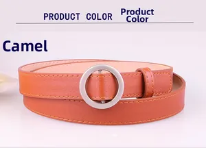 Detail view of camel skinny belt with round matte silver buckle and stitched edges