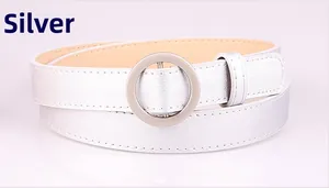 Detail of silver skinny belt with round metal buckle and tidy stitching on inner lining