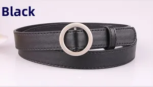 Close-up detail of black leather belt with polished silver round metal buckle