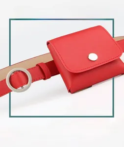 Detail view of red lychee grain leather belt and matching square pouch with silver buckle
