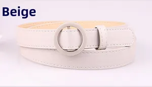 Detail of grey thin waist belt featuring a round metal buckle and lychee texture