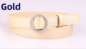 Detailed view of women's slim gold belt with a polished silver circular pin buckle
