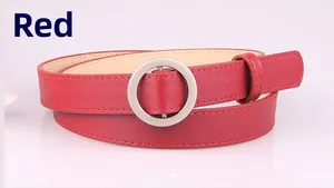 Detail of red faux leather belt featuring a silver metal round buckle and precise stitching