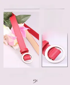 Detail of red leather belt with matte white alloy round buckle and holeless adjustable strap