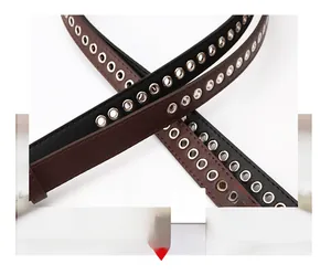 Close-up of black and brown PU leather belts with full-length silver metal grommet detail