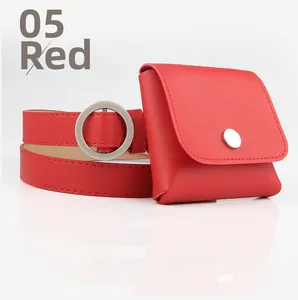 Detail of red leather belt bag set with silver circular buckle and mini square pouch