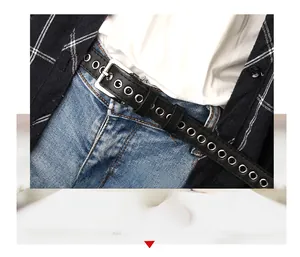 Close-up of black leather belt with double rows of silver metal eyelets and square buckle