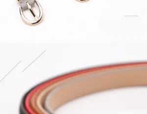Dettaglio di cinture sottili da donna in ecopelle con fibbie ovali dorate e lucide
