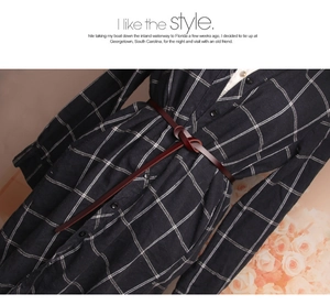 Close-up of a slim dark brown leather belt knotted over a dark blue plaid shirt dress