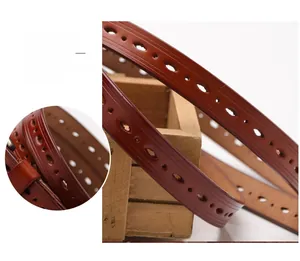Detail of genuine brown leather belt with laser cutouts and smooth oil-finished edges