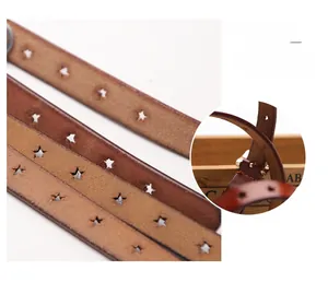 Detail of genuine brown leather belt with decorative star-shaped hollow pattern
