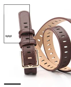 Close-up of brown litchi pattern leather belt with golden square buckle and cutouts