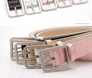 Close-up of colorful glittering PU leather skinny belts with matte silver alloy buckles