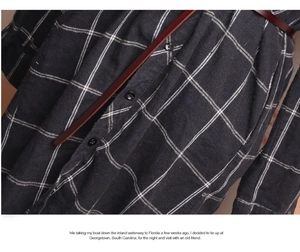 Close-up of a classic black and white plaid shirt dress with a thin dark brown leather belt