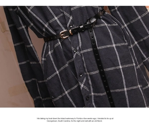 Detail of black leather skinny belt with star-shaped cutouts and gold buckle on dress